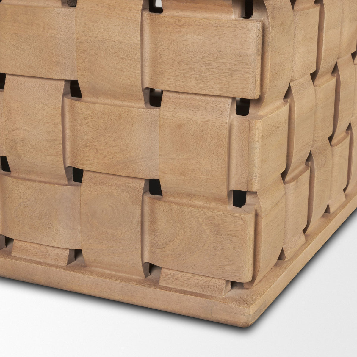 Close-up of the Varelle Coffee Table woven carved corner showing the interlocking block pattern and light brown wood finish.