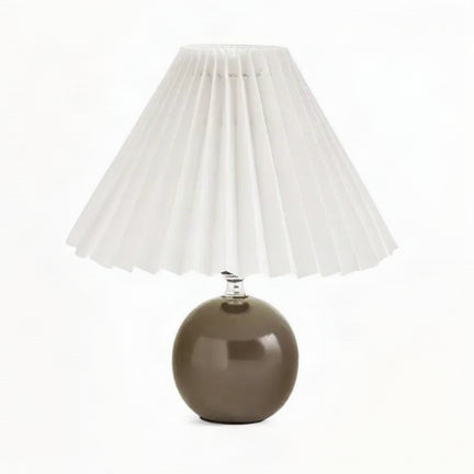 Vela Ceramic Table Lamp with a glossy dark brown rounded base and white pleated shade.