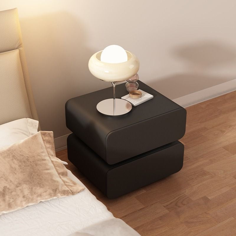 A beige modern wood and leather nightstand with two tiers, placed against a neutral background.