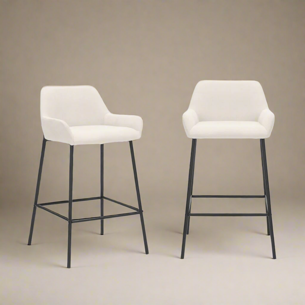 Two white bar stools with black legs on a beige background