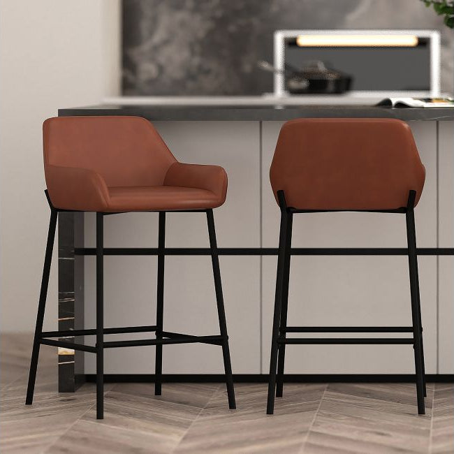 Two brown bar stools with black legs in a kitchen setting.