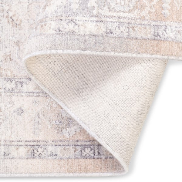 Folded corner of the Verona vintage-style area rug showcasing its soft, low pile face and durable woven underside backing.