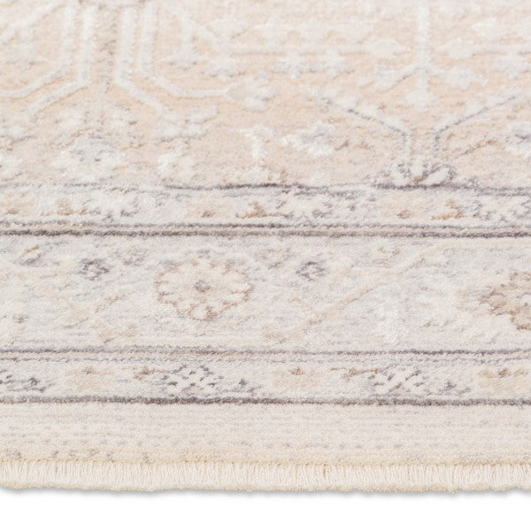 Macro close-up of the short, textured fringe and faded traditional oriental pattern on the edge of the Verona area rug.