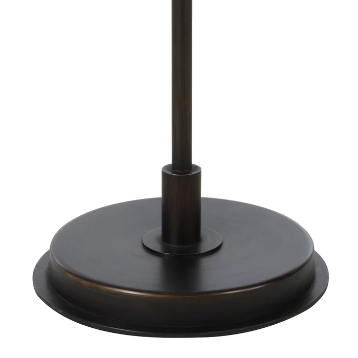 Close-up of the Vienne floor lamp's round dark antique bronze iron base.