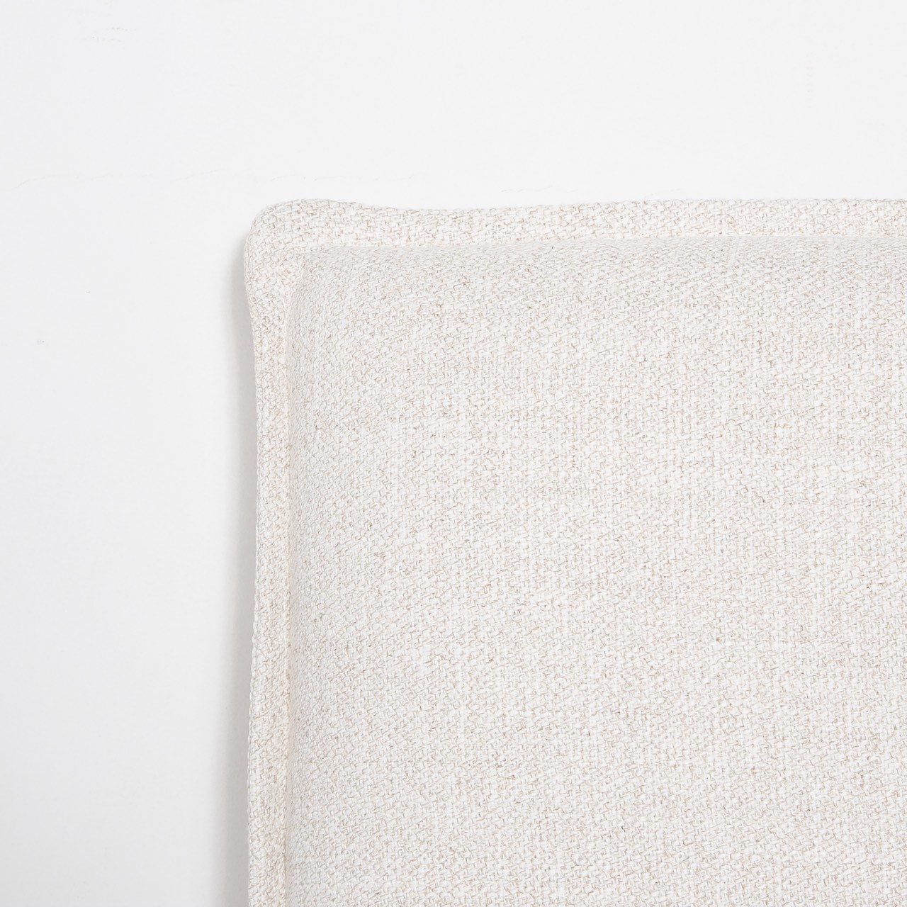 Close-up of the Vivienne bed headboard corner showcasing the high-quality French seam flange upholstery detail.