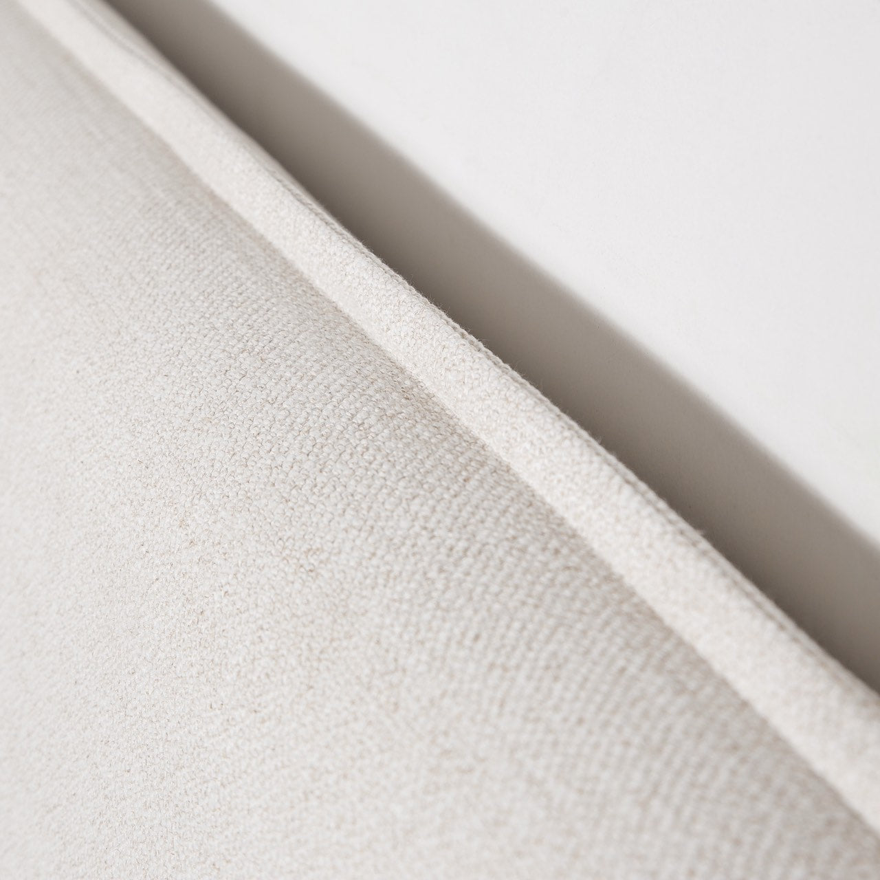 Detailed profile shot of the Vivienne bed headboard edge emphasizing the architectural flange seam tailoring.