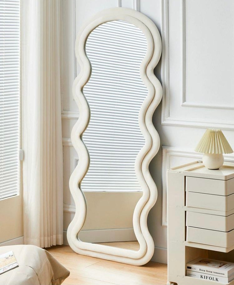 Wavy Floor Full Body Mirror with sculptural curved frame placed in a bright modern bedroom corner.