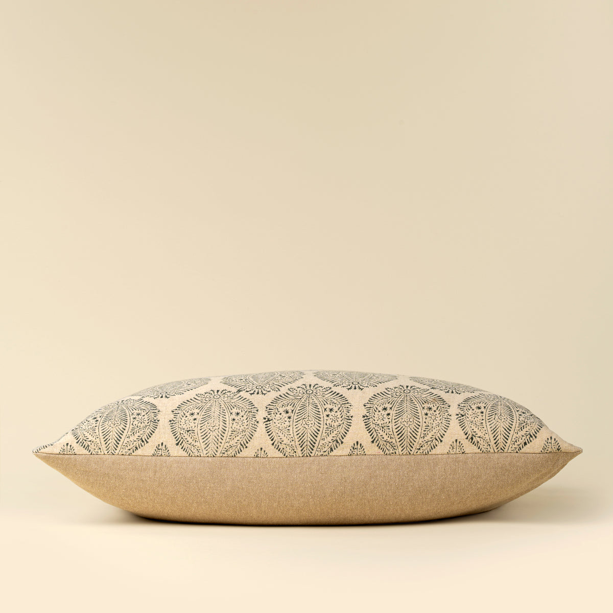 Decorative pillow with leaf pattern on a beige background