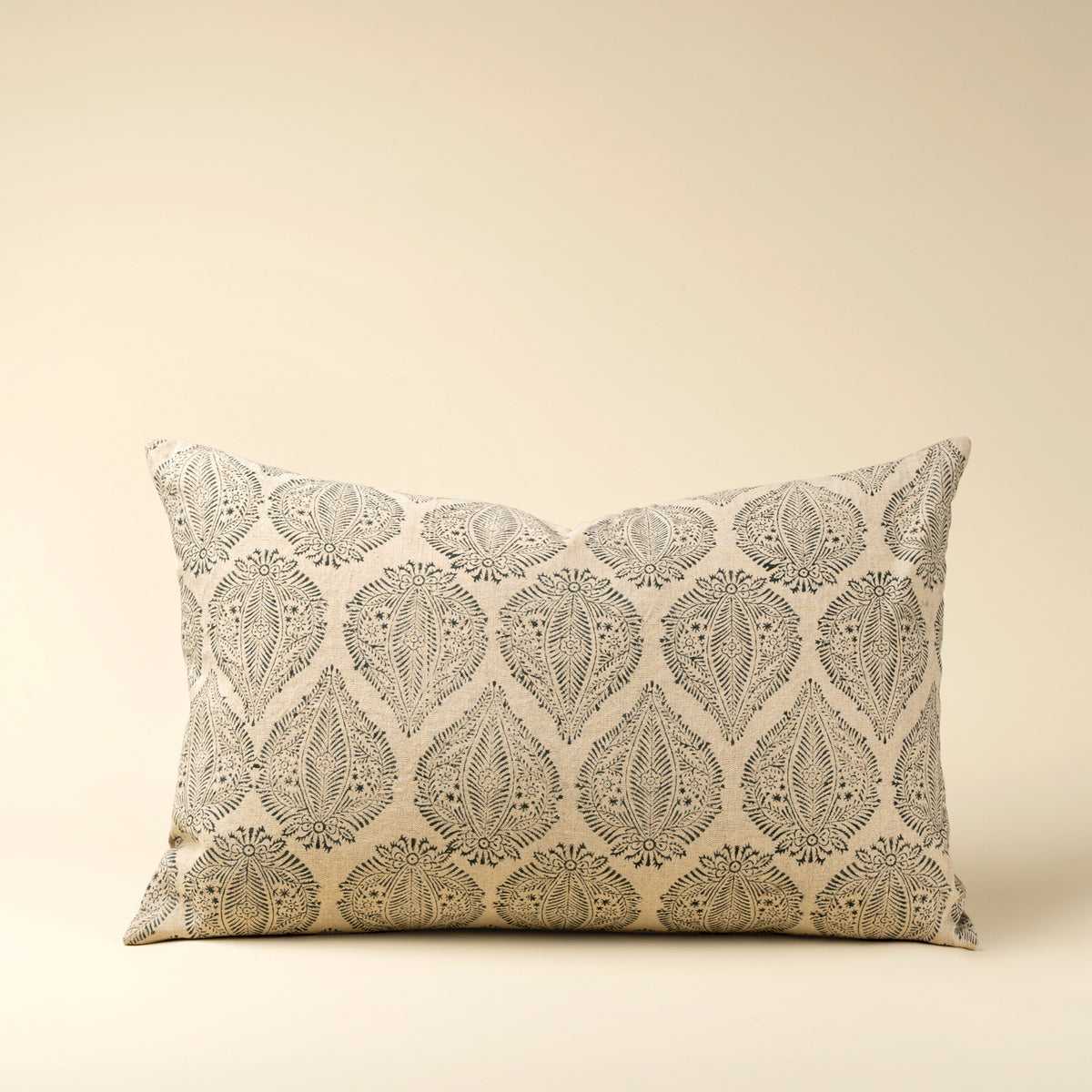 Decorative pillow with leaf pattern on a beige background