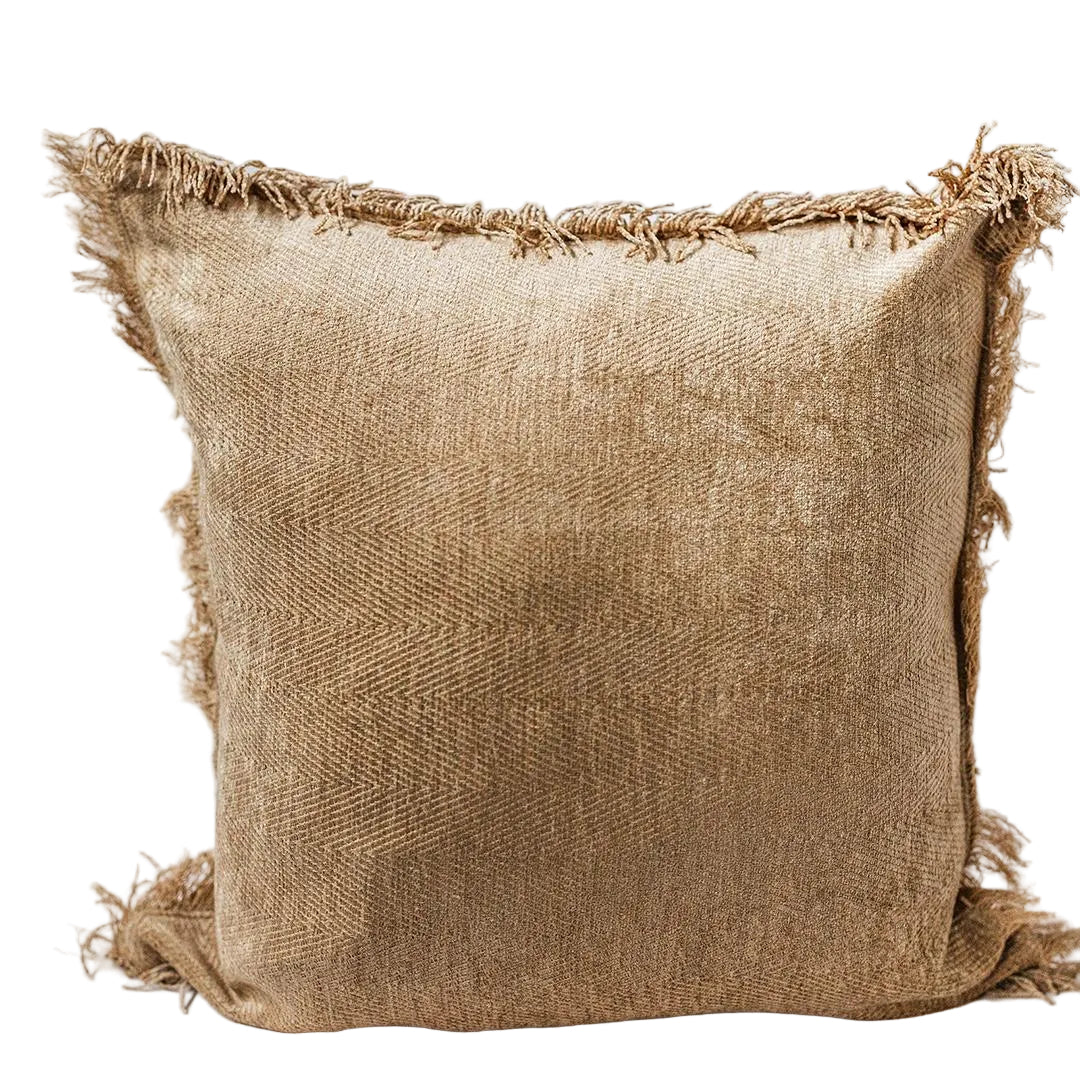 Textured brown pillow with frayed edges on a light gray background