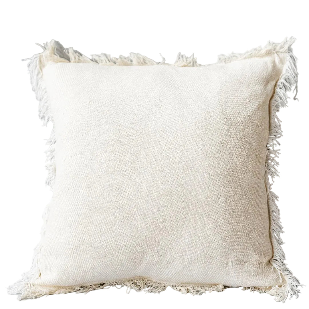 White pillow with frayed edges on a gray background