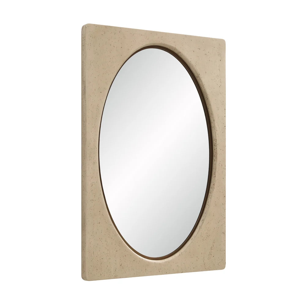 Angled view of the Adeline Faux Travertine Wall Mirror showing the inset oval mirror and softly rounded beige resin frame.