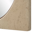 Close-up of the Adeline Faux Travertine Wall Mirror highlighting the speckled beige resin frame and inset oval mirror edge.