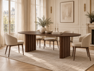 Adrian Dining Table – a modern dining room scene featuring a dark wood oval dining table with a fluted pedestal base
