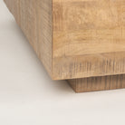 Close-up shot of the Aero coffee table base showing the sturdy recessed wood plinth construction.