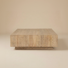 Front studio view of the Aero square plinth coffee table featuring a solid mango wood block design.