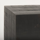 Dark brown solid wood block with a textured surface on a white background