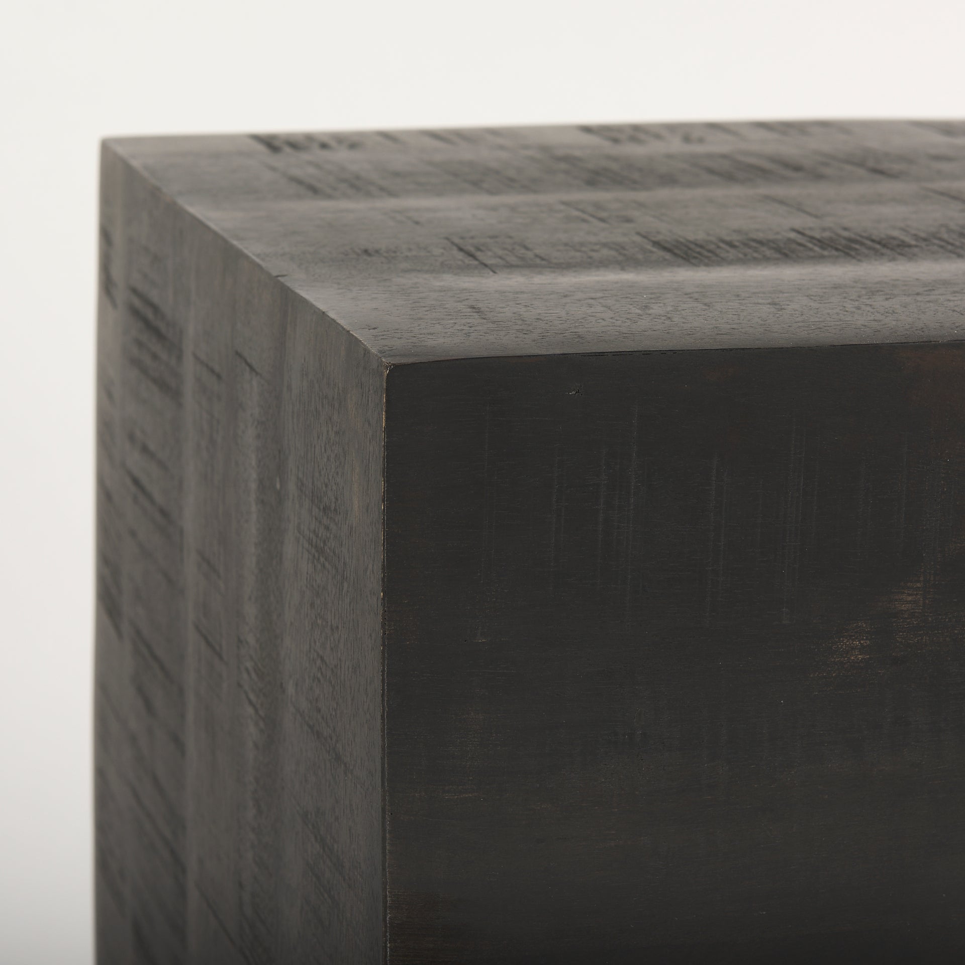Dark brown solid wood block with a textured surface on a white background
