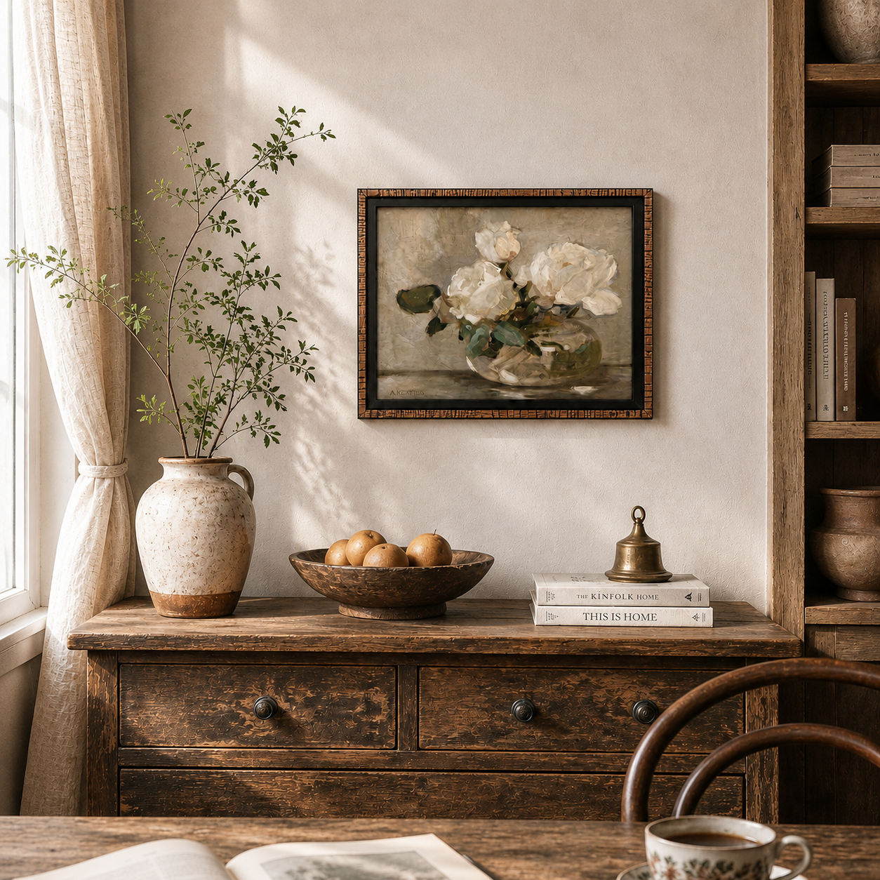Vintage interior with wooden dresser, framed artwork, and a cup of coffee.