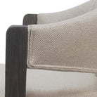 Bar stool with beige cushioned seat and dark wooden legs