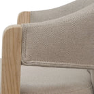 Close-up of a chair with beige fabric and wooden armrests on a white background