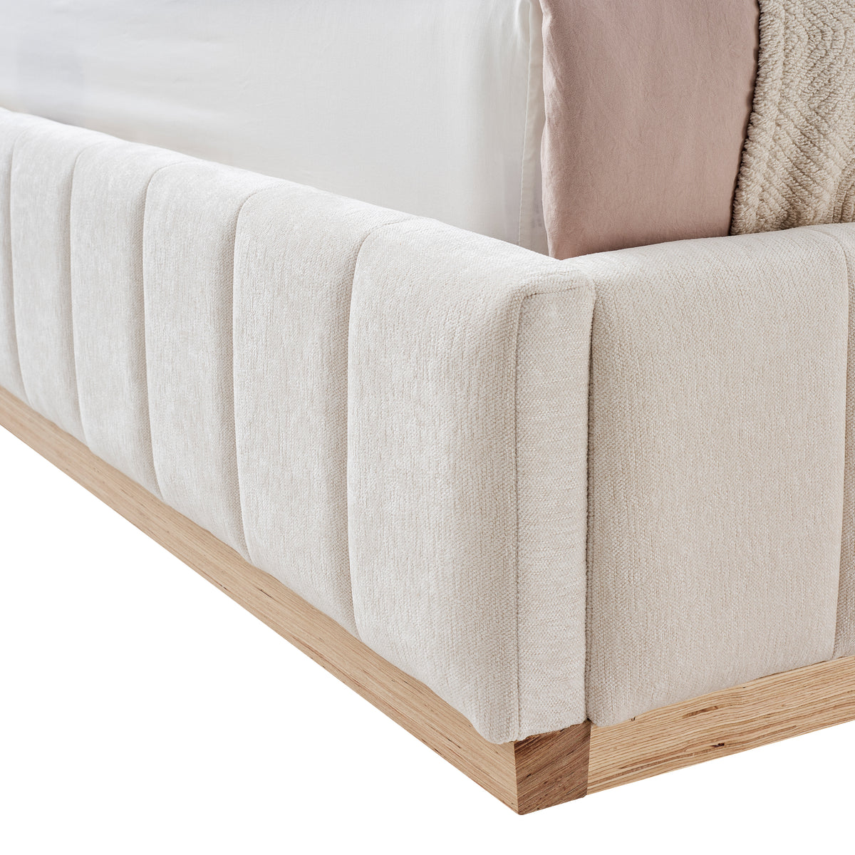Close-up of a tufted footboard upholstered bed with solis ash wood base on a white background