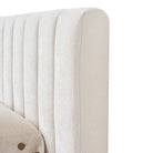 Close-up of a tufted beige linen headboard on a white background