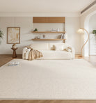 Amara Rug in a soft cream tone styled in a modern living room with a beige sofa, wood accents, and neutral decor