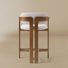 Ash wood counter stool with linen cushioned seat and backrest on a beige background