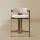 Ash wood counter stool with linen cushioned seat and backrest on a beige background
