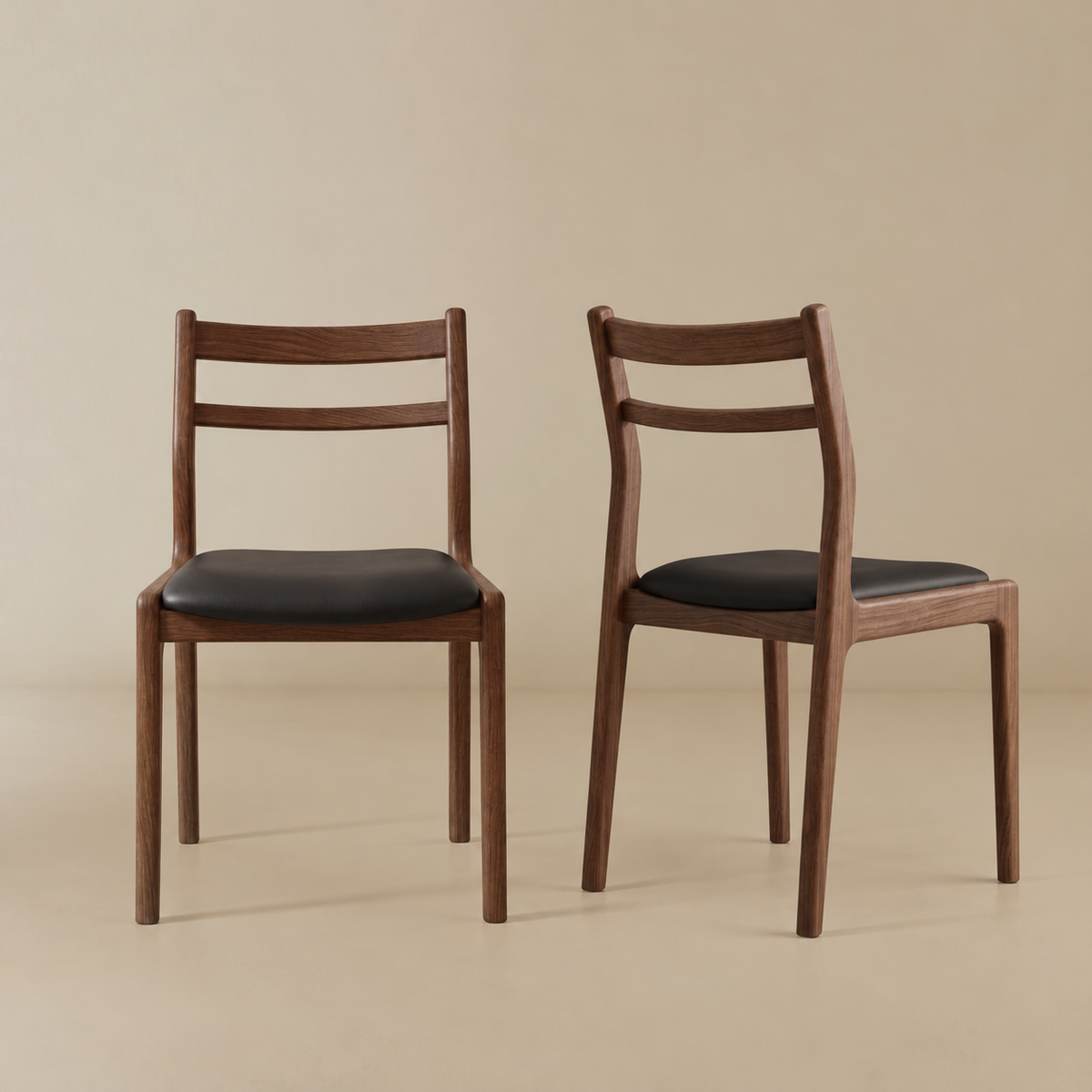 Aspen classic dining chair with black upholstered seats, shown from the front and side against a warm beige studio background.