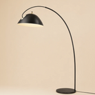 Black arch floor lamp on a beige background