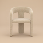Front view of the modern Archway dining chair featuring a curved back, thick seat, and textured beige upholstery