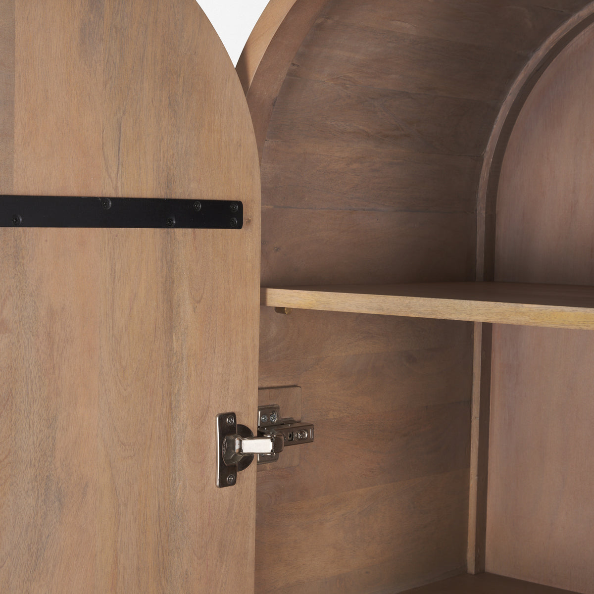 Interior detail of Arco curio cabinet showing adjustable shelf pegs and sturdy metal door hinge