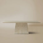 Front view of the natural travertine Ardella dining table on a beige background