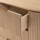 Close up of the Arden dresser with a drawer open, showing the solid wood construction, smooth glides, and ribbed texture detail