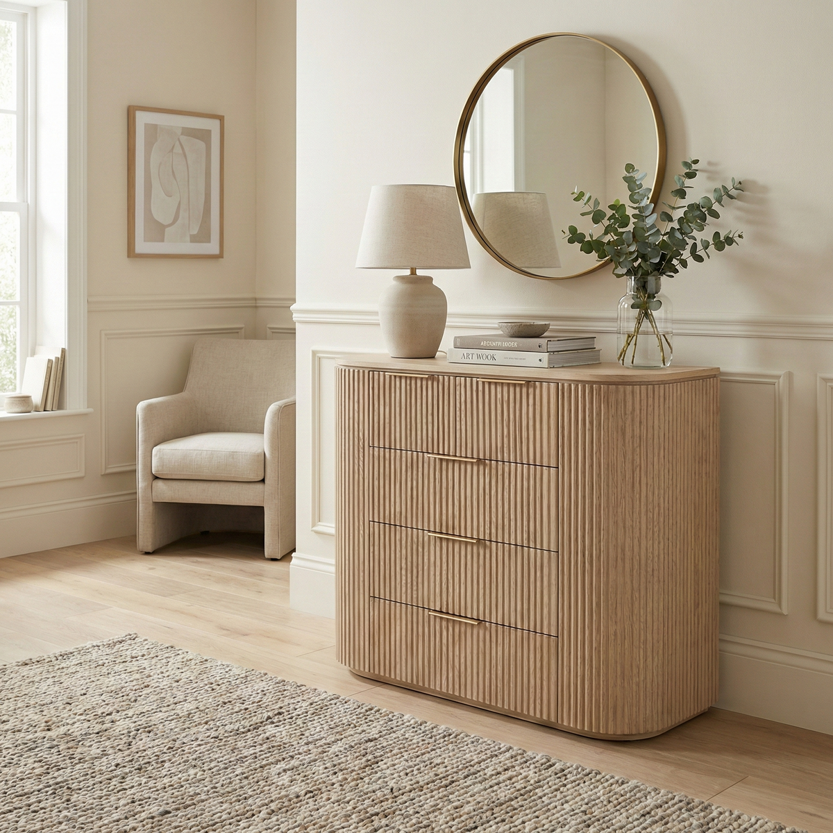 Arden curved wood dresser used as an entryway console table, styled with a gold mirror and vase of eucalyptus
