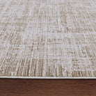 Textured beige and brown rug on a wooden floor