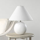 Arlo White Marble Sphere Table Lamp on round wooden side table beside cream armchair in minimal neutral living space