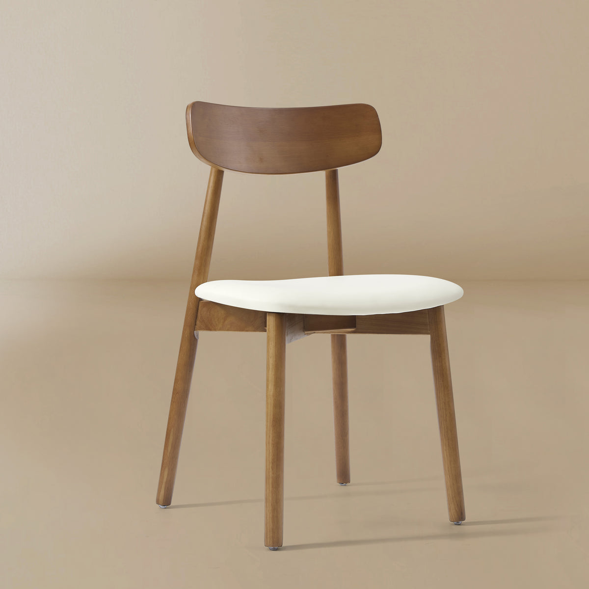 Angle view of the Ash Classic dining chair featuring a solid wood frame with a dark walnut finish, curved backrest, and cream upholstered seat