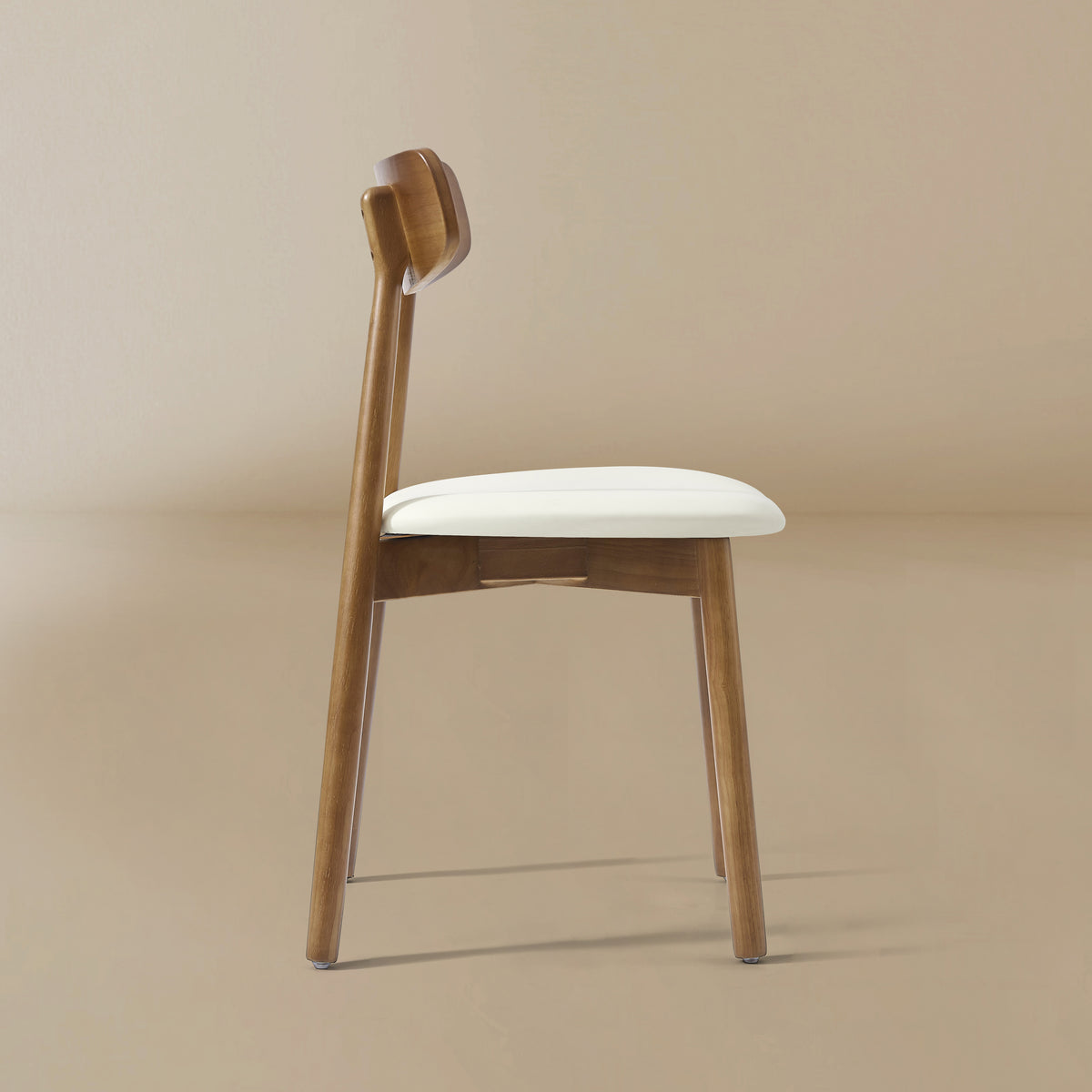 Side profile of the Ash Classic dining chair featuring a solid wood frame with a dark walnut finish, curved backrest, and cream upholstered seat