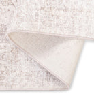 The Audrey traditional rug folded over to show its soft-touch pile and sturdy woven backing.