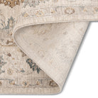 Folded corner of the Aurelia Vintage Floral Rug in Ivory showing the light floral surface and woven backing.