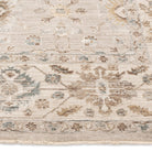 Close-up of the Aurelia Vintage Floral Rug in Sand showing its warm beige floral border, soft pile, and finished edge.