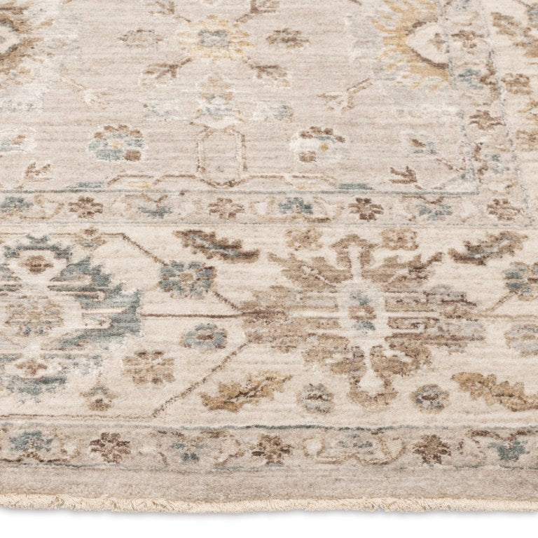 Close-up of the Aurelia Vintage Floral Rug in Sand showing its warm beige floral border, soft pile, and finished edge.