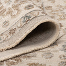 Folded Aurelia Vintage Floral Rug in Sand showing the soft pile, finished edge, and woven backing.