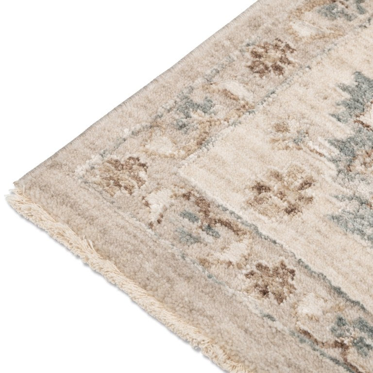 Close-up of the Aurelia Vintage Floral Rug in Sand showing its soft floral motifs in cream, beige, brown, and muted blue.