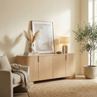 Aurelian oak buffet styled in a warm neutral room with a mushroom lamp and dried botanicals next to a beige armchair