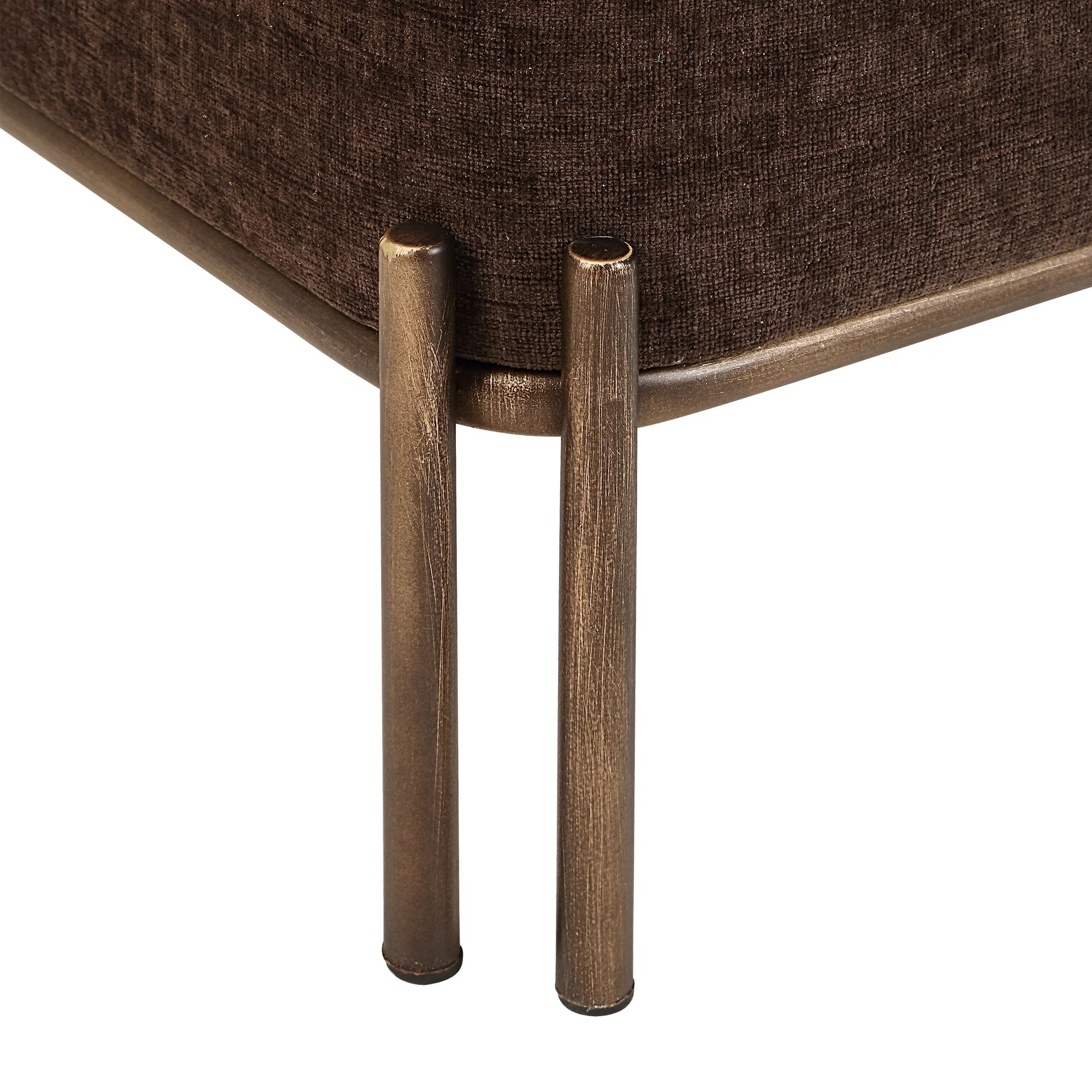 Close-up of the painted brass iron leg detail on the brown Aurelie Linen Accent Stool.