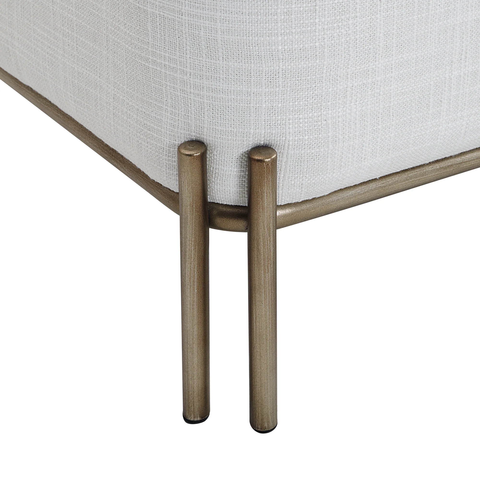 Close-up of the painted brass iron leg detail on the white Aurelie Linen Accent Stool.